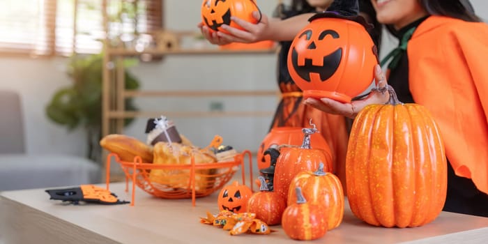 Halloween concept mom and daughter preparing to celebrate at home together beautifully decorated.