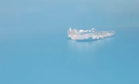 Design Mouth Guard. Transparent Dental Aligners For Human Maxillary And Mandibular Teeth On Blue Background. Braces, Alignment Of Teeth. Orthodontic Concept. Dental Care. Copy Space. Horizontal.