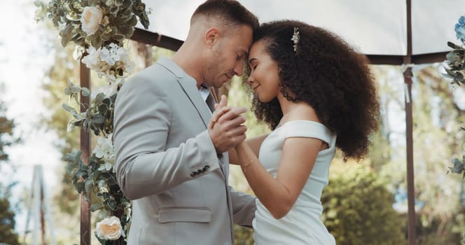 Couple, wedding and dancing with touch, outdoor and commitment in celebration, love and smile. Interracial marriage, fashion and happy in nature, peace and romance of union and trust.