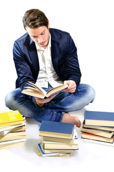 Young adult reading books, sitting on white background in casual clothing and jeans.