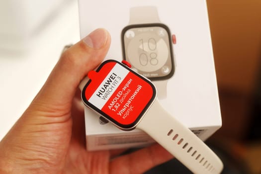 Tyumen, Russia-June 20, 2024: Huawei Watch Fit 3 with a red screen displaying the text AMOLED