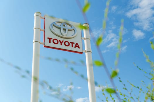 Tyumen, Russia-August 10, 2024: prominent dealership sign features the Toyota logo against a bright blue sky