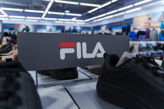 Tyumen, Russia-August 11, 2024: Fila sneaker is prominently displayed with detailed lacing and a visible brand tag, viewed inside a retail shop.