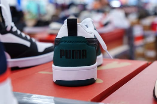 Tyumen, Russia-August 11, 2024: Trendy athletic shoe Puma is prominently showcased in a retail setting, highlighting its unique color combination and design