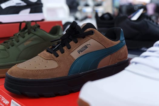 Tyumen, Russia-August 11, 2024: Trendy athletic shoe Puma is prominently showcased in a retail setting, highlighting its unique color combination and design