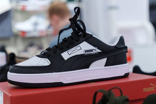 Tyumen, Russia-August 11, 2024: Stylish athletic shoe Puma displayed in a retail store with a modern design and vibrant colors