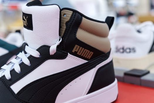 Tyumen, Russia-August 11, 2024: Trendy athletic shoe Puma is prominently showcased in a retail setting, highlighting its unique color combination and design