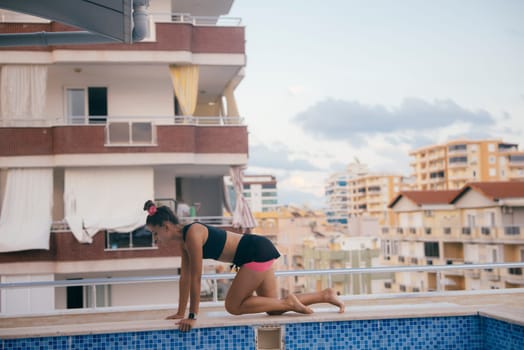 In an urban environment, a dedicated fitness enthusiast engages in exercising activities near a vibrant pool