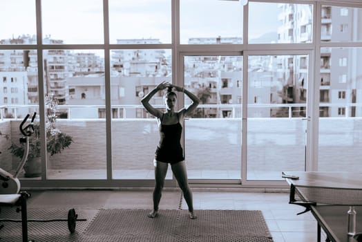 A stylish and dedicated athlete is working out hard in a bright, modern, and contemporary gym setting today
