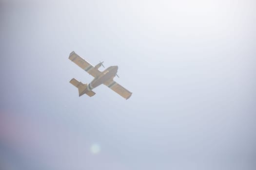 fire fighting plane flying through smoke after fighting a fire in the boise foothills