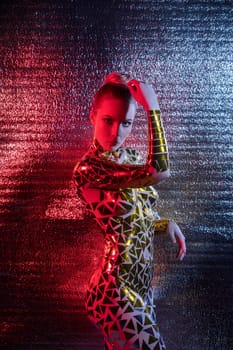 Beautiful blonde with gold tape body art shot against silver wall