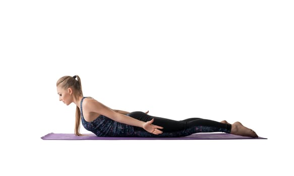 Young pretty girl doing sports exercises on a mat profile isolated view on white background