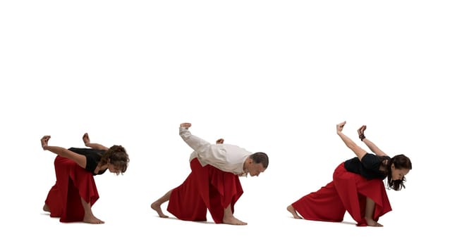 Two women and their male trainer doing yoga exercises isolated on white