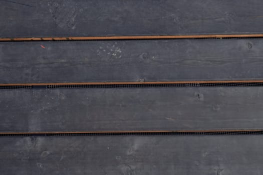 The texture of the board is made of ebony. The background is made of dark wood. Natural material.