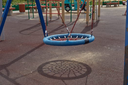 A playground on the street. Hanging swing for relaxing with children.