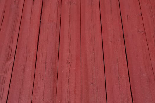 The background texture is a vertical red floorboard. Natural material. Construction and renovation.
