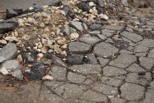 Close-up of cracks in the asphalt surface, damage to the pavement in the spring,, crack in the asphalt from time