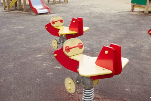 A playground on the street. Hanging swing for relaxing with children. Wooden Swing in the form of airplanes.