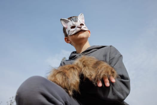 A catmasked teenager performs Quadrobics with gloves mimicking a felines movements, Quadrobics - Sport