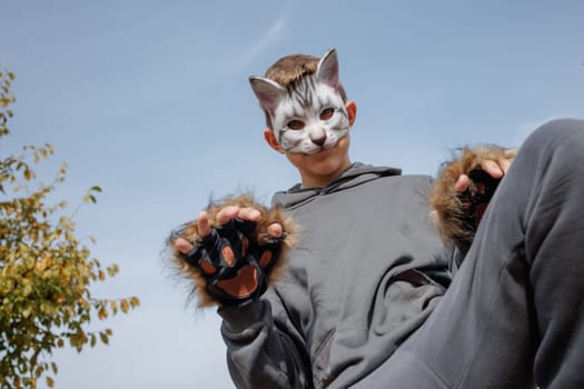 Teenager in a cat mask and gloves doing Quadrobics . aggressive Teenager in a Quadrobics mask jumps like a cat, Quadrobics - Sport