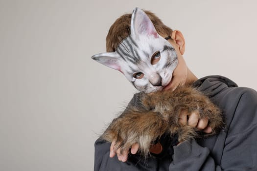 portrait quadrobics Teenager in cat mask on gray background , studio photo , imitating cat movements, Quadrobics - Sport