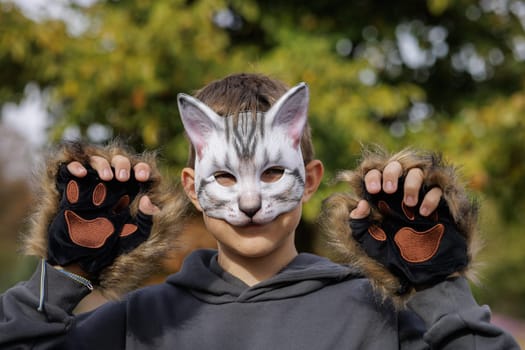 Teenager in a cat mask and gloves doing Quadrobics . aggressive Teenager in a Quadrobics mask jumps like a cat, Quadrobics - Sport