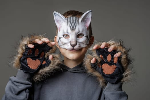 portrait quadrobics Teenager in cat mask on gray background , studio photo , imitating cat movements, Quadrobics - Sport