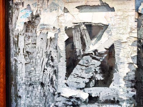 Layers of peeling paint expose a weathered surface, illustrating urban decay and the passage of time in an abandoned area.