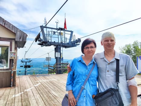 Abzakovo, Russia - July 18, 2024: Visitors enjoy the clear mountain views at the cable car station in Abzakovo, Russia, as they prepare for an adventure.