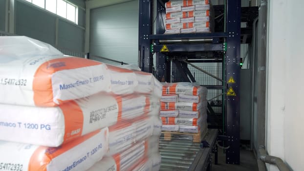 Serbia - Belgrade, August 25, 2022: view inside of a warehouse. Creative. Goods on a conveyor belt moving automatically