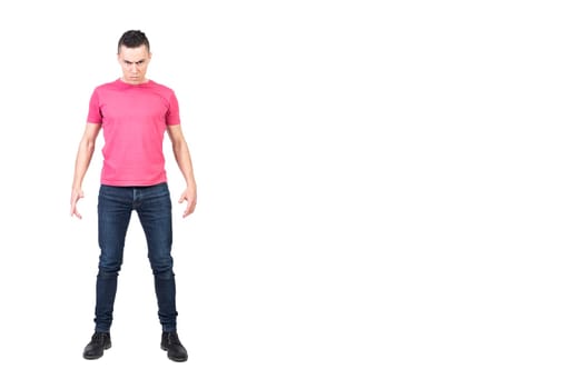 Full body male bully in casual clothes frowning and looking at camera while initiating conflict against white background