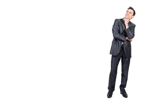 Full length of content pensive male entrepreneur in suit touching chin and looking up on white isolated background