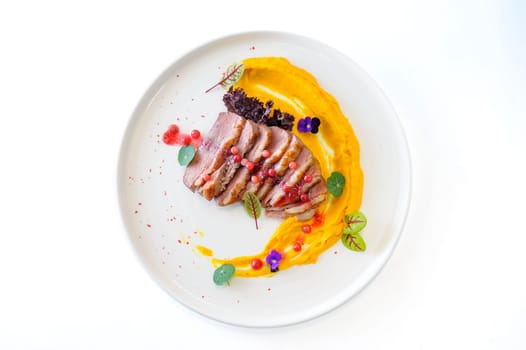 Duck fillet with sweet potato puree and lingonberries. High quality photo