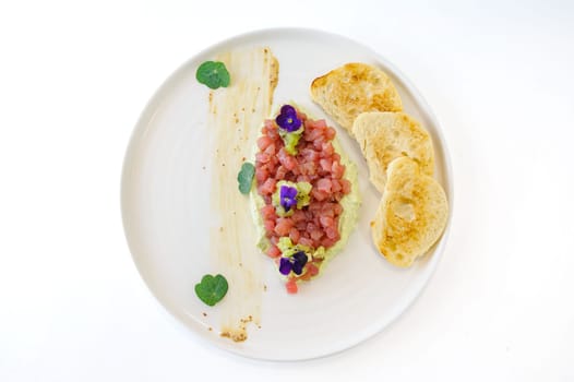 Tuna tartare with mint kiwi avocado cream and ciabatta croutons. High quality photo