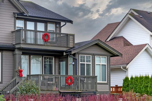 Fragment of a residential house with Christmas decorations on overcast sky background