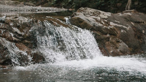 Beautiful waterfall on the river in mountainous region. Creative. Calming small waterfall and cold flowing stream