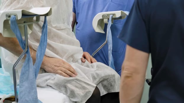 Surgical operation. Creative. A bright large room where surgeons can be seen performing surgery on people dressed in special hospital clothes for convenience. High quality 4k footage