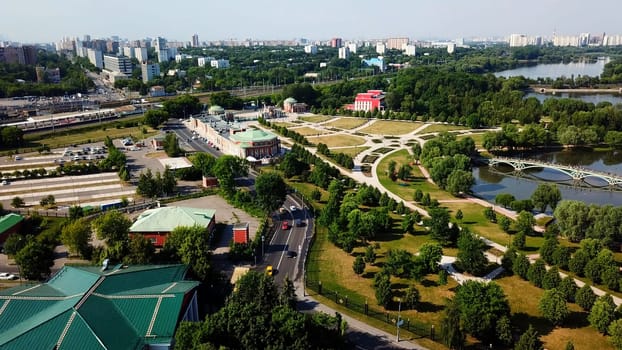 Bright summer landscape from a drone. Creative.A beautiful green city with tall buildings, houses, parks, green forests and a blue river. High quality 4k footage