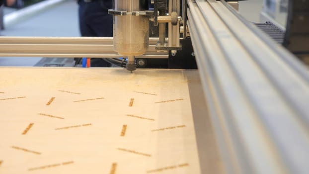 Industrial Wood Carving Machine. Media. Automated machine cutting patterns on wood. Wood cutting on industrial automated machine.
