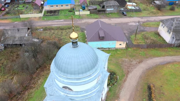 Top view of church in village. Clip. Church in small old village in summer. Small church in dirty old village with wooden houses.