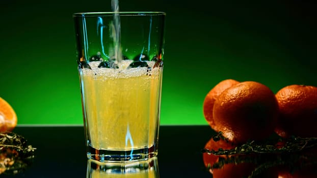 Refreshing colorful drink in a transparent glass. Stock clip. Prepared juciy cocktail at the night club party