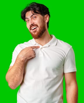 Smiling man in a white polo shirt standing confidently against a bright green background close up