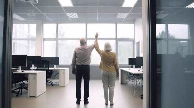 A man and a woman are both standing excitedly in an office, with their arms raised high in the air, celebrating a significant achievement or moment