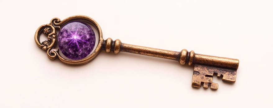 Antique brass key with purple gemstone on white background.