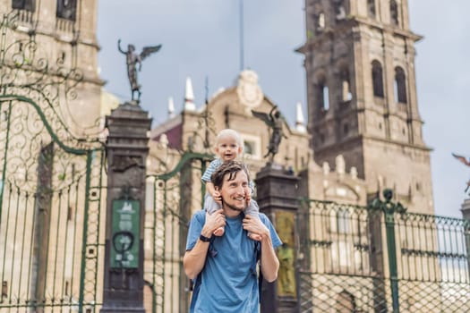 Father and son tourists in front of Catedral de Puebla, Mexico. Travel, cultural heritage, and historic architecture exploration concept.