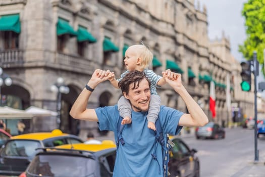 Father tourist with his toddler son walking through the colorful colonial streets of Puebla, Mexico. Travel, cultural exploration, and vibrant architecture concept.