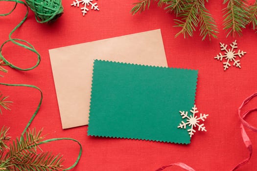 Christmas green greeting card mockup with eco-friendly xmas, new year decorations on a red textile background, eco Christmas holiday concept, eco decor banner
