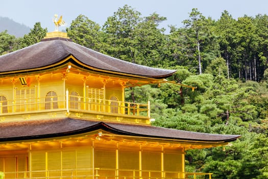 The world famous Kinkakuji Temple (The Golden Pavilion) in Kyoto, Japan on a warm autumn morning