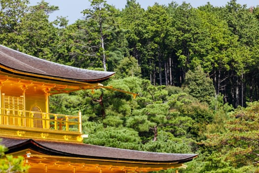 The world famous Kinkakuji Temple (The Golden Pavilion) in Kyoto, Japan on a warm autumn morning