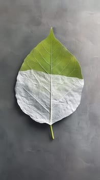 Half-painted leaf on a textured surface.